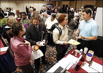 Amy Forst, left, and Michael Forst, right, talk with National Job Fair attendees, Kendall Wiley, second from left, and Andrew Callahan, second from right, in Richmond, Va., Friday, Oct. 2, 2009. The unemployment rate rose to 9.8 percent in September, the highest since June 1983, as employers cut far more jobs than expected.(AP Photo/Steve Helber)